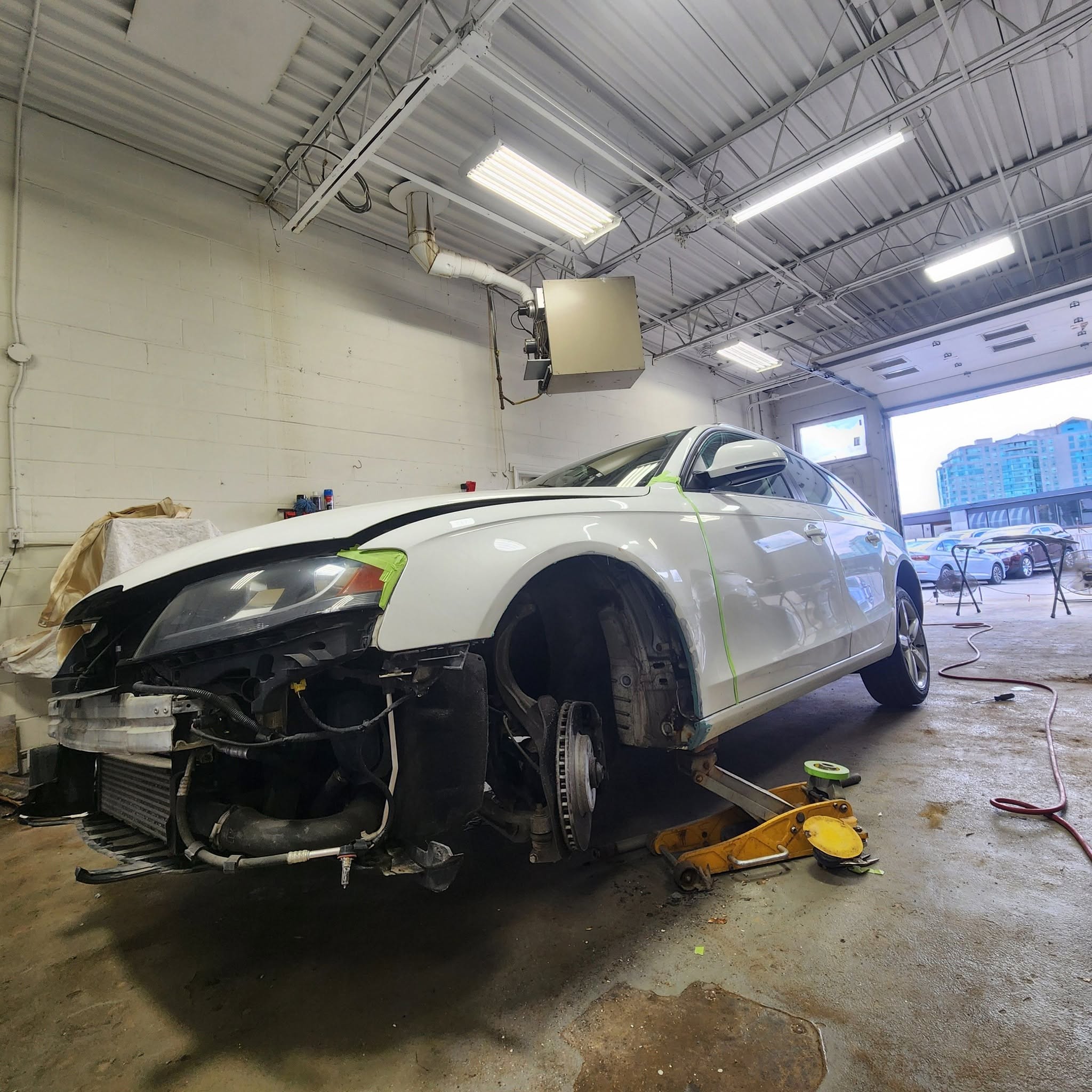 Vehicle undergoing auto body rust repair in Markham, with the front end disassembled