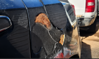 Rusted panel before cutting, welding, and refinishing